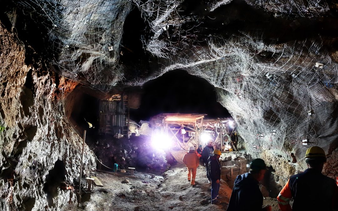 a group of people standing inside of a cave